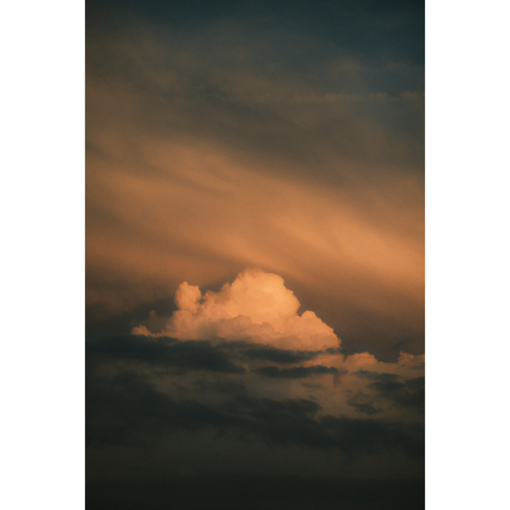 a puffy cloud glowing in sunset